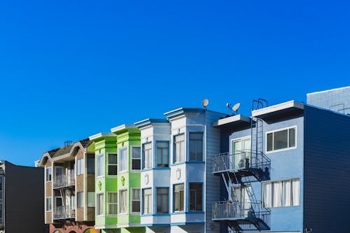 Rainbow colored row houses in San Francisco against a clear blue sky